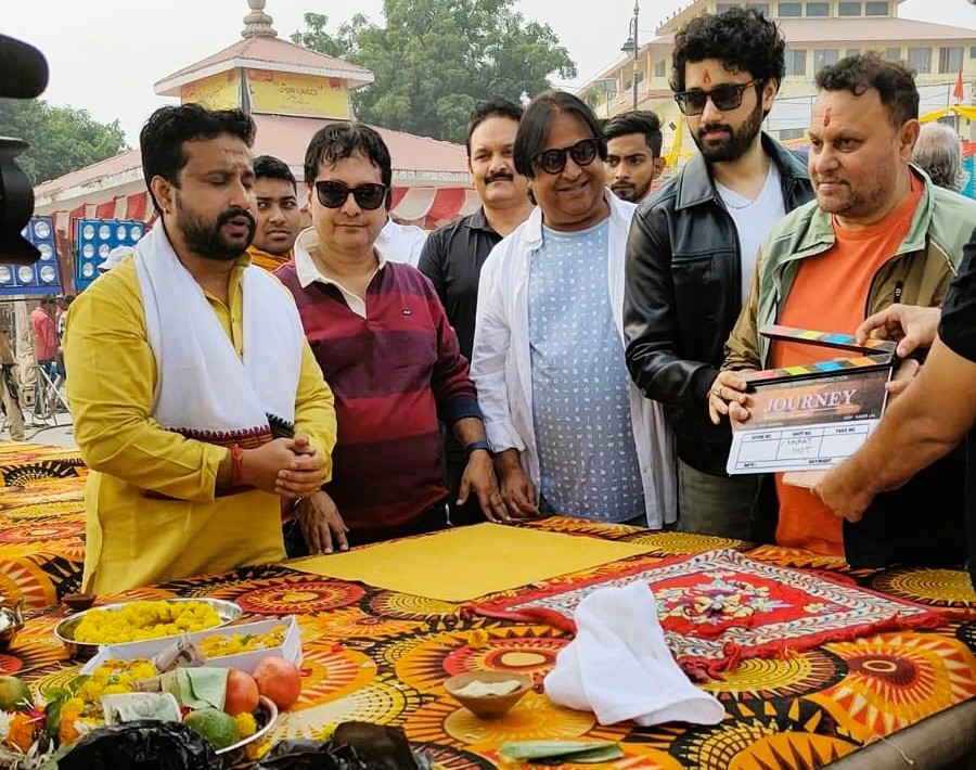 Temple priest performing aarti with decorated lamps